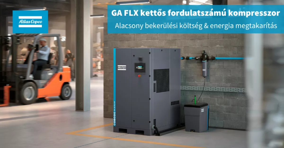 A large grey machine next to a brick wall

Description automatically generated